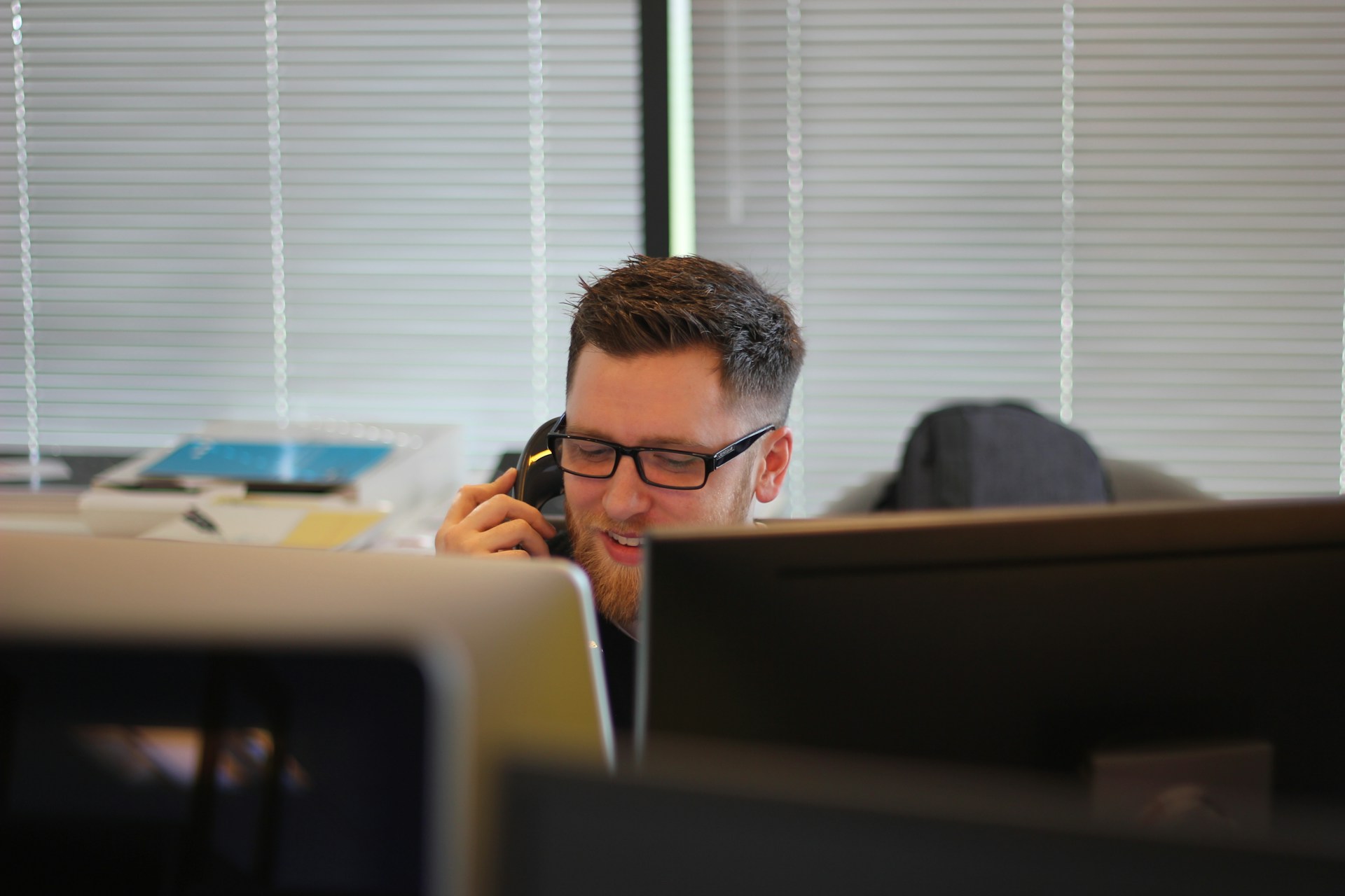 Accountant on a phone call at their desk, providing professional advisory support.