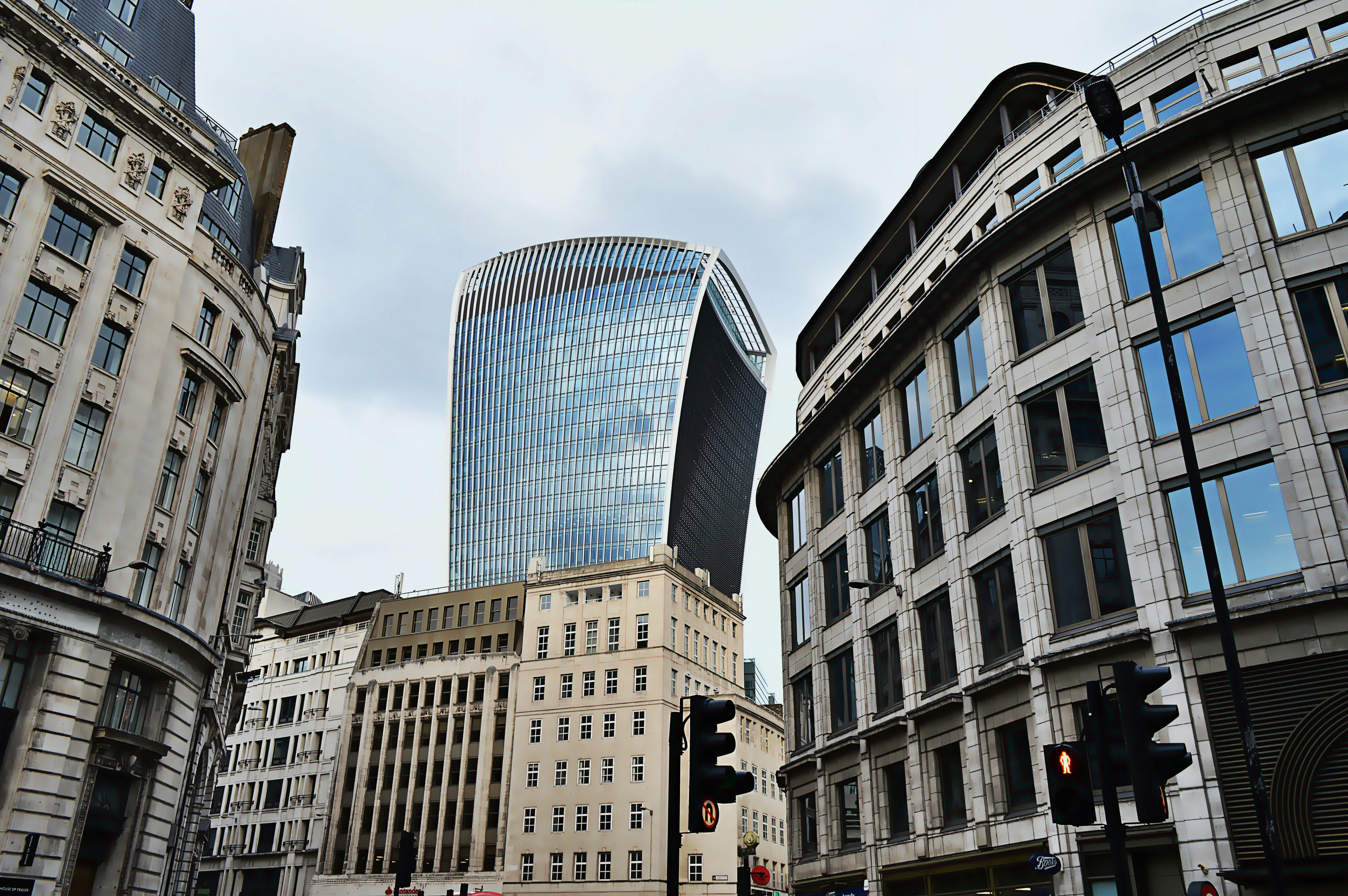 London street-level view of modern and historic architecture under a cloudy sky